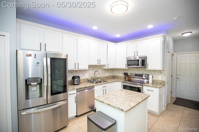 2062 Preserve Cir W, Canton, MI 48188 - kitchen featuring stainless steel appliances, a sink, light tile patterned flooring, white cabinets, and decorative backsplash