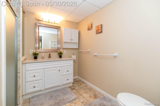 2062 Preserve Cir W, Canton, MI 48188 - bathroom featuring vanity, toilet, a paneled ceiling, baseboards, and tile patterned flooring