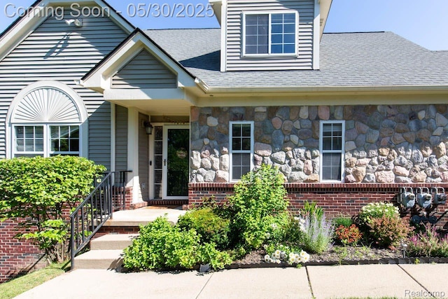 2062 Preserve Cir W, Canton, MI 48188 - view of exterior entry featuring stone siding, a shingled roof, and brick siding