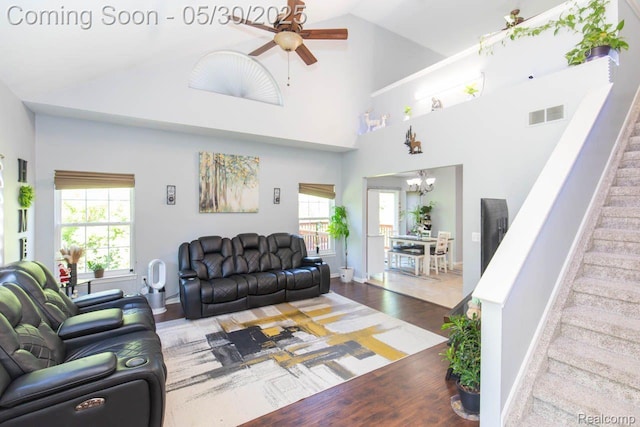 2062 Preserve Cir W, Canton, MI 48188 - living room featuring a ceiling fan, wood finished floors, stairs, a chandelier, and high vaulted ceiling