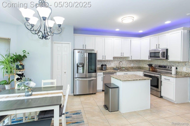 2062 Preserve Cir W, Canton, MI 48188 - kitchen featuring stainless steel appliances, a sink, a chandelier, tasteful backsplash, and white cabinets