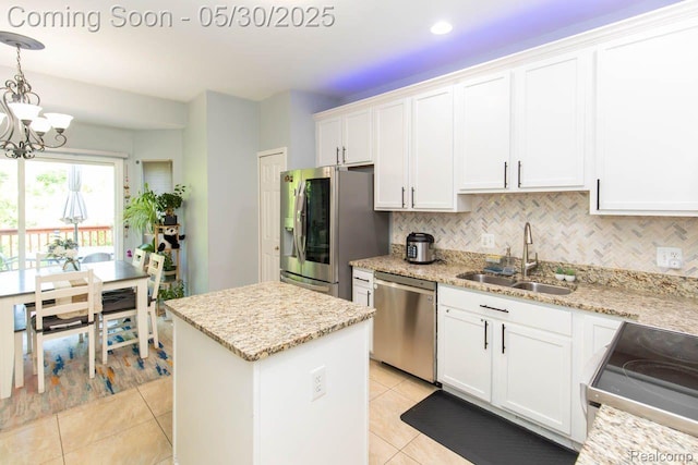 2062 Preserve Cir W, Canton, MI 48188 - kitchen with appliances with stainless steel finishes, a sink, a kitchen island, a chandelier, and light tile patterned flooring