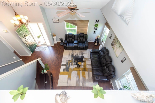 2062 Preserve Cir W, Canton, MI 48188 - living room featuring wood finished floors, a towering ceiling, ceiling fan, a chandelier, and baseboards