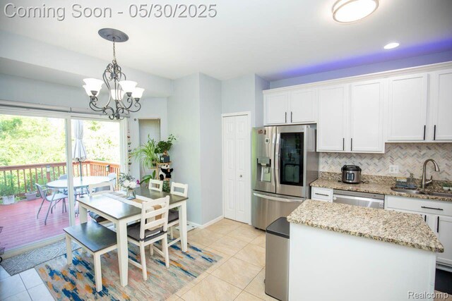 2062 Preserve Cir W, Canton, MI 48188 - kitchen with appliances with stainless steel finishes, a sink, light tile patterned flooring, backsplash, and white cabinetry