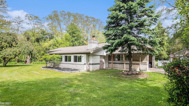1590 W Rolston Rd, Linden, MI 48451 - back of house with a lawn and a chimney