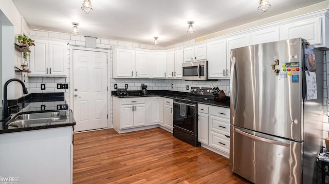 1590 W Rolston Rd, Linden, MI 48451 - kitchen featuring appliances with stainless steel finishes, a sink, and white cabinets