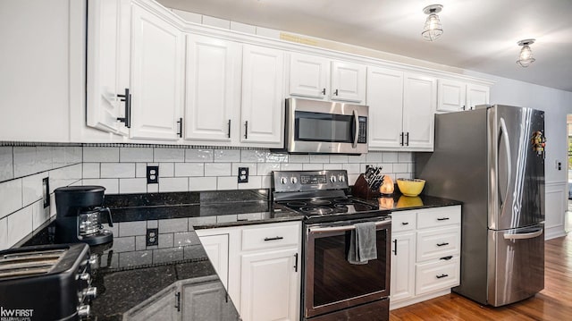 1590 W Rolston Rd, Linden, MI 48451 - kitchen with appliances with stainless steel finishes, white cabinets, decorative backsplash, and wood finished floors