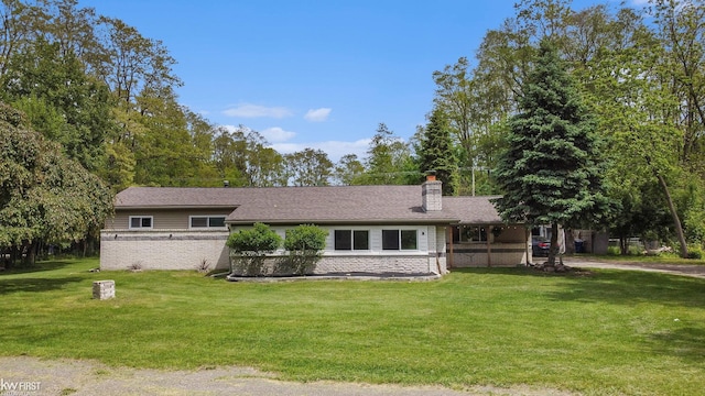 1590 W Rolston Rd, Linden, MI 48451 - ranch-style house with a chimney, a front yard, and brick siding