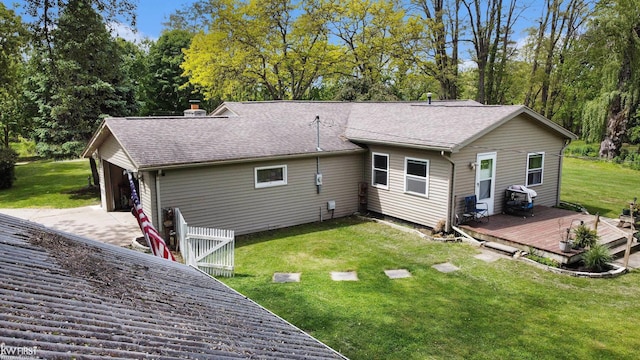 1590 W Rolston Rd, Linden, MI 48451 - rear view of property featuring a wooden deck, a lawn, a chimney, driveway, and a shingled roof