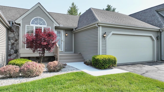 17 E Drake Dr, Saginaw, MI 48603 - view of front of house featuring an attached garage, driveway, and a shingled roof