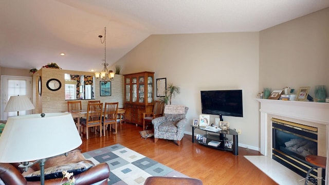 17 E Drake Dr, Saginaw, MI 48603 - living room featuring a chandelier, wood finished floors, a high end fireplace, vaulted ceiling, and baseboards