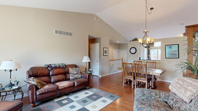17 E Drake Dr, Saginaw, MI 48603 - living room featuring a chandelier, lofted ceiling, wood finished floors, and baseboards