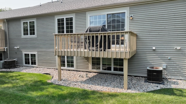 17 E Drake Dr, Saginaw, MI 48603 - back of house with central AC unit, a deck, and roof with shingles