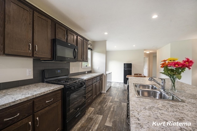 532 48th St, Grand Junction, MI 49056 - kitchen featuring black appliances, a sink, dark wood-type flooring, dark brown cabinetry, and recessed lighting