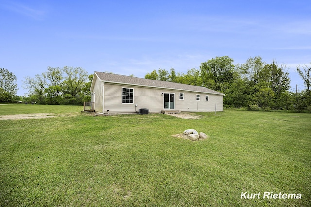 532 48th St, Grand Junction, MI 49056 - rear view of house with a lawn and central air condition unit