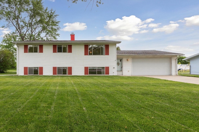 530 Manitou Rd, Saint Joseph, MI 49085 - tri-level home featuring a front yard, concrete driveway, a garage, and a chimney