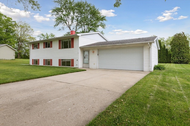 530 Manitou Rd, Saint Joseph, MI 49085 - tri-level home featuring a front lawn, driveway, a chimney, and an attached garage