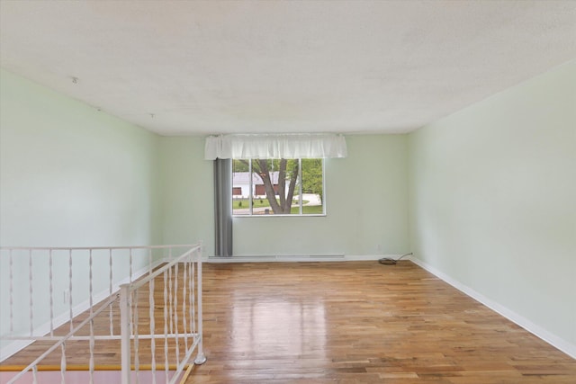 530 Manitou Rd, Saint Joseph, MI 49085 - empty room with wood finished floors, baseboards, and a baseboard radiator