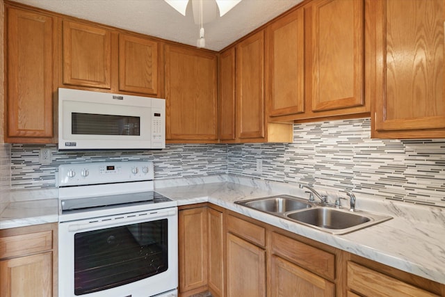 530 Manitou Rd, Saint Joseph, MI 49085 - kitchen featuring white appliances, a sink, decorative backsplash, and brown cabinets