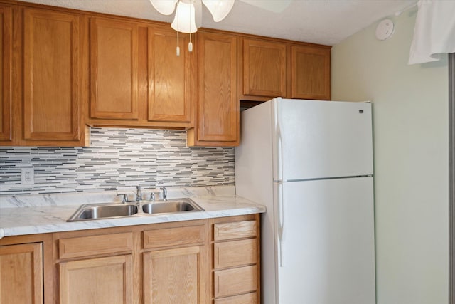 530 Manitou Rd, Saint Joseph, MI 49085 - kitchen with freestanding refrigerator, a sink, light countertops, and backsplash