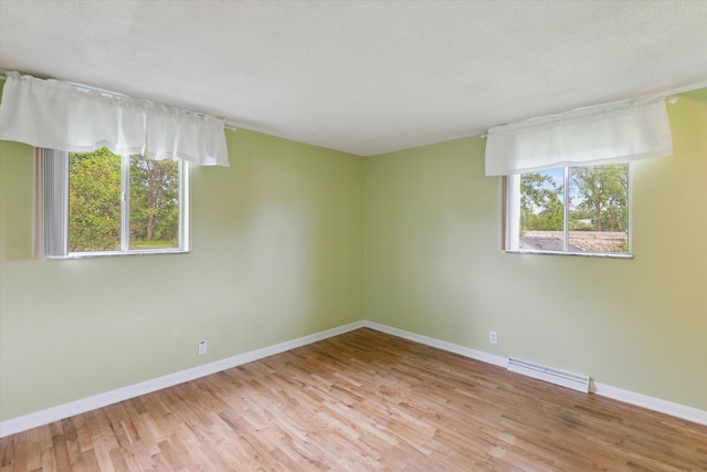 530 Manitou Rd, Saint Joseph, MI 49085 - spare room with wood finished floors, baseboards, and a baseboard radiator