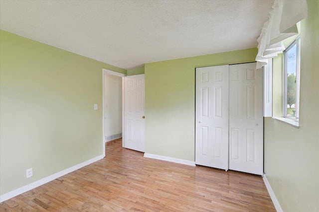 530 Manitou Rd, Saint Joseph, MI 49085 - unfurnished bedroom with light wood-type flooring, baseboards, and a closet