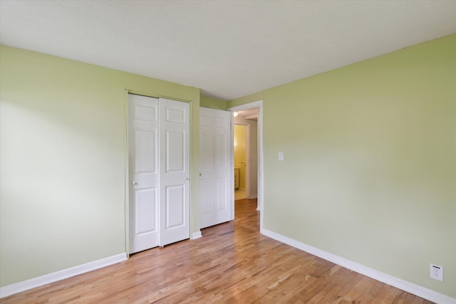 530 Manitou Rd, Saint Joseph, MI 49085 - unfurnished bedroom featuring light wood finished floors, baseboards, and a closet