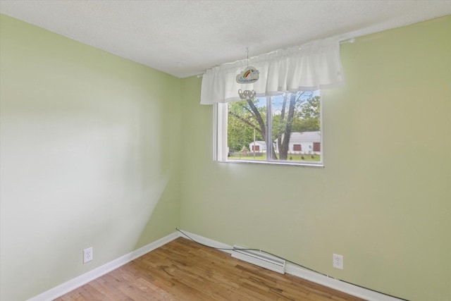 530 Manitou Rd, Saint Joseph, MI 49085 - empty room with wood finished floors, baseboards, and a textured ceiling