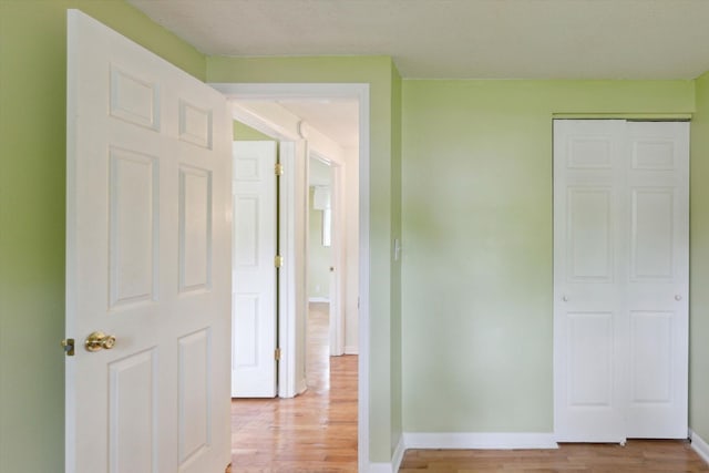 530 Manitou Rd, Saint Joseph, MI 49085 - unfurnished bedroom featuring light wood finished floors, baseboards, and a closet