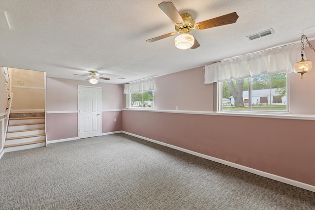 530 Manitou Rd, Saint Joseph, MI 49085 - unfurnished room with ceiling fan, a textured ceiling, carpet flooring, stairway, and baseboards