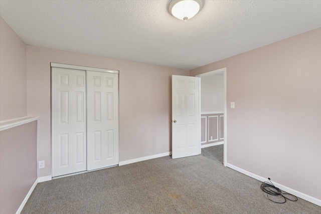 530 Manitou Rd, Saint Joseph, MI 49085 - unfurnished bedroom with carpet, a closet, a textured ceiling, and baseboards