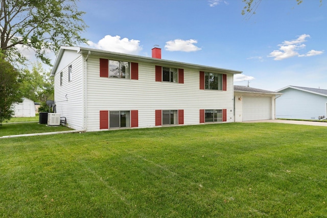530 Manitou Rd, Saint Joseph, MI 49085 - view of front of property with a chimney, a front yard, central AC unit, driveway, and a garage