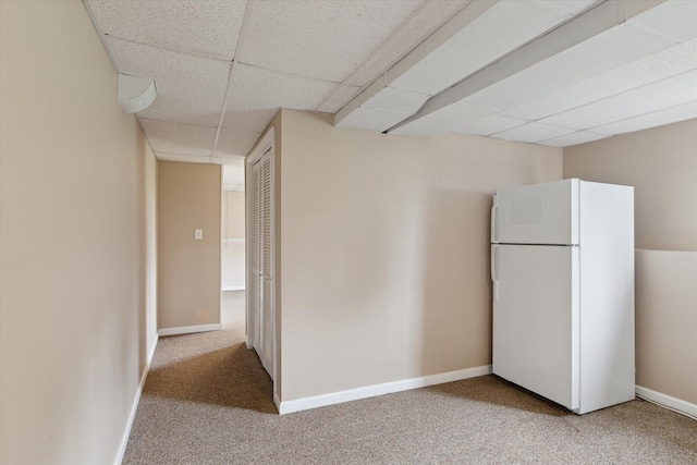 530 Manitou Rd, Saint Joseph, MI 49085 - below grade area featuring freestanding refrigerator, a drop ceiling, carpet floors, and baseboards