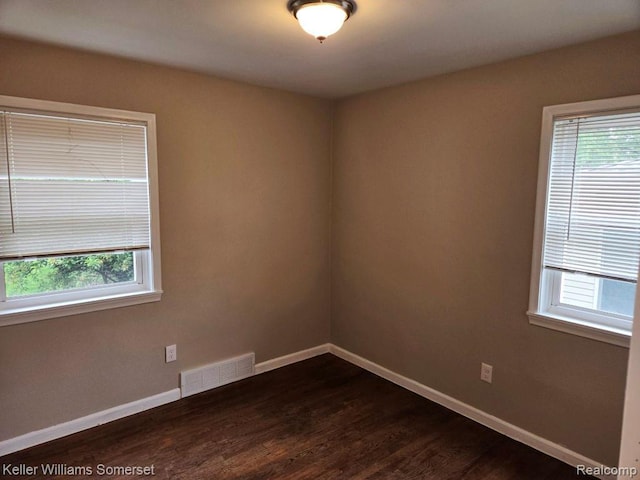 174 Hickory Dr, Troy, MI 48083 - empty room featuring dark wood-style floors and plenty of natural light