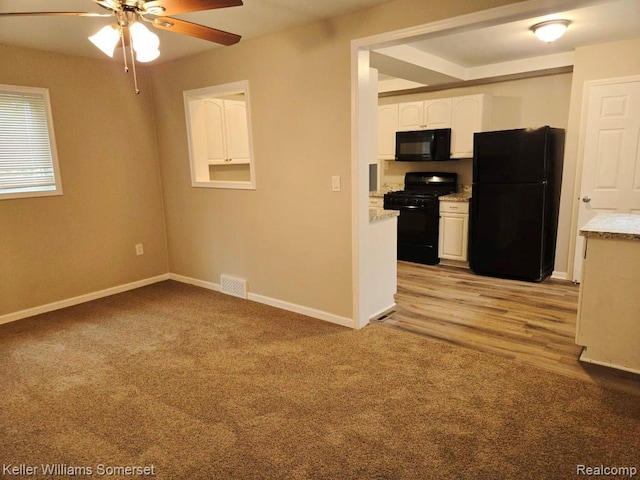 174 Hickory Dr, Troy, MI 48083 - kitchen featuring black appliances, a ceiling fan, light carpet, and white cabinetry
