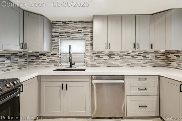 11651 Mason Rd, Webberville, MI 48892 - kitchen featuring dishwasher, a sink, black range, gray cabinetry, and decorative backsplash