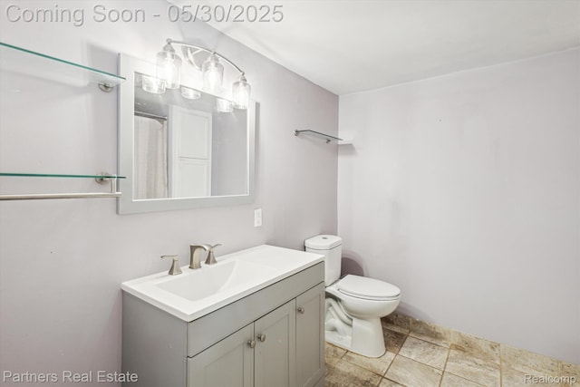 11651 Mason Rd, Webberville, MI 48892 - bathroom with vanity, toilet, and stone finish floors