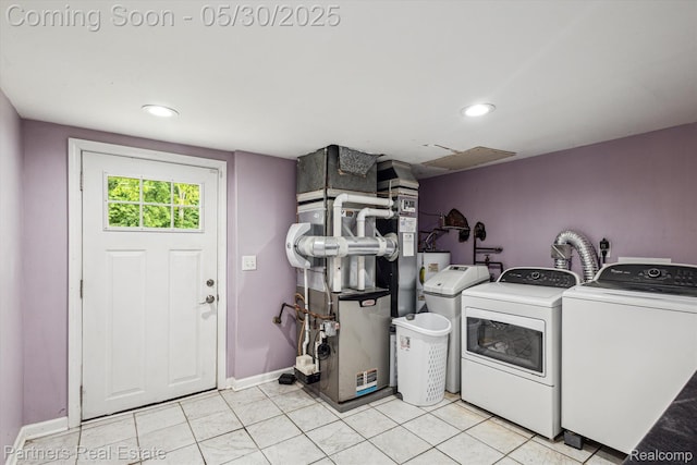 11651 Mason Rd, Webberville, MI 48892 - laundry area featuring washing machine and dryer, heating unit, baseboards, recessed lighting, and light tile patterned flooring