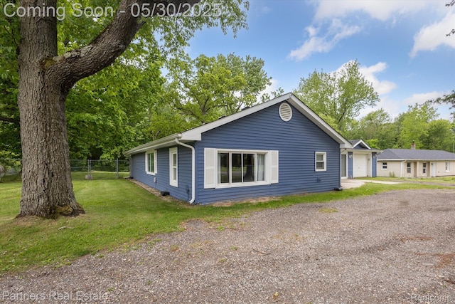 11651 Mason Rd, Webberville, MI 48892 - view of home's exterior featuring a garage and driveway