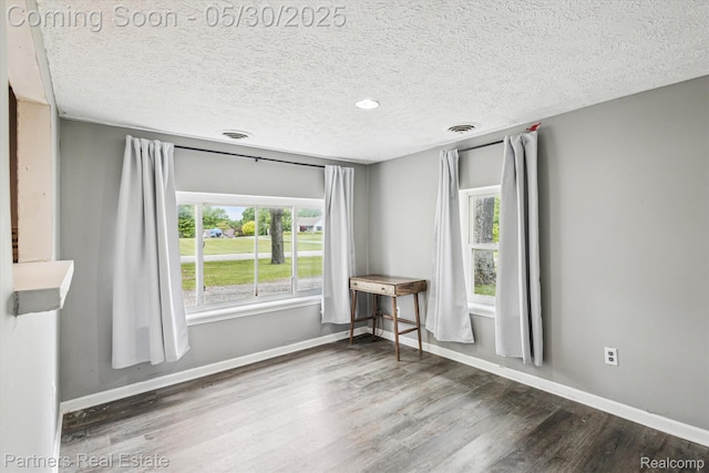 11651 Mason Rd, Webberville, MI 48892 - empty room with wood finished floors, a textured ceiling, baseboards, and recessed lighting