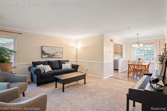 22810 Lilac St, Farmington, MI 48336 - carpeted living area with a chandelier, healthy amount of natural light, and baseboards