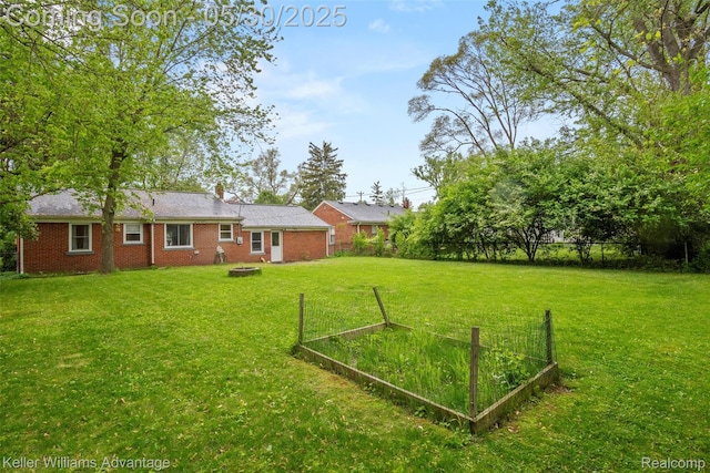 22810 Lilac St, Farmington, MI 48336 - view of yard featuring a garden and an outdoor fire pit