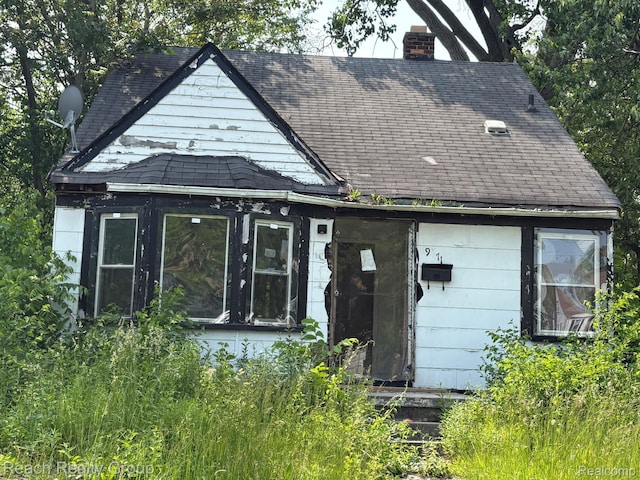 19471 Asbury Park, Detroit, MI 48235 - rear view of house with a shingled roof and a chimney