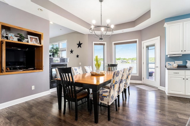 9077 24th Ave, Jenison, MI 49428 - dining room with dark wood finished floors, baseboards, a chandelier, a glass covered fireplace, and recessed lighting