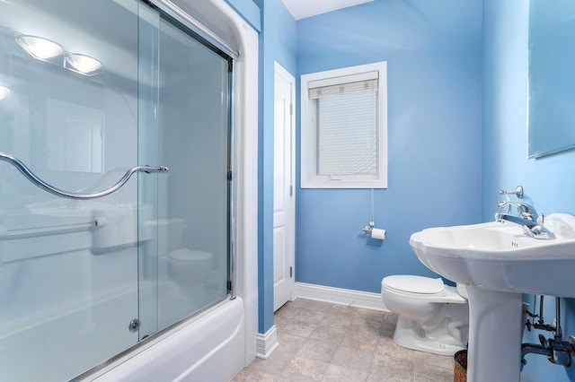 9077 24th Ave, Jenison, MI 49428 - full bathroom featuring baseboards, toilet, and combined bath / shower with glass door