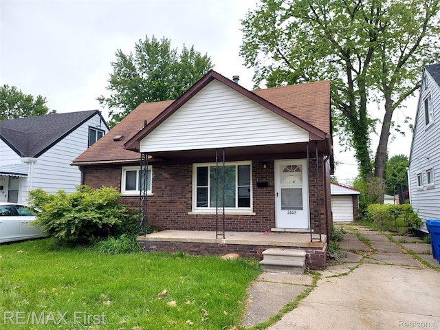 24449 Lauren Ave, Warren, MI 48089 - view of front facade featuring a porch and brick siding