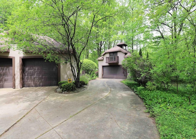 10466 W Farrand Rd, Montrose, MI 48457 - view of front of property with stucco siding and concrete driveway