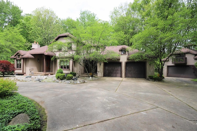 10466 W Farrand Rd, Montrose, MI 48457 - view of front of home featuring a balcony, stucco siding, driveway, and an attached garage