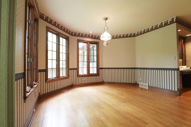 10466 W Farrand Rd, Montrose, MI 48457 - empty room with wallpapered walls and wood finished floors