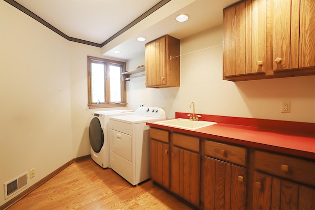 10466 W Farrand Rd, Montrose, MI 48457 - laundry area featuring independent washer and dryer, cabinet space, light wood-style floors, crown molding, and recessed lighting